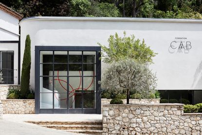 white painted exterior of Fondation CAB renovated on a sunny day