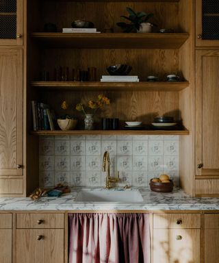 Kitchen sink with wooden cabinetry and traditional tiles