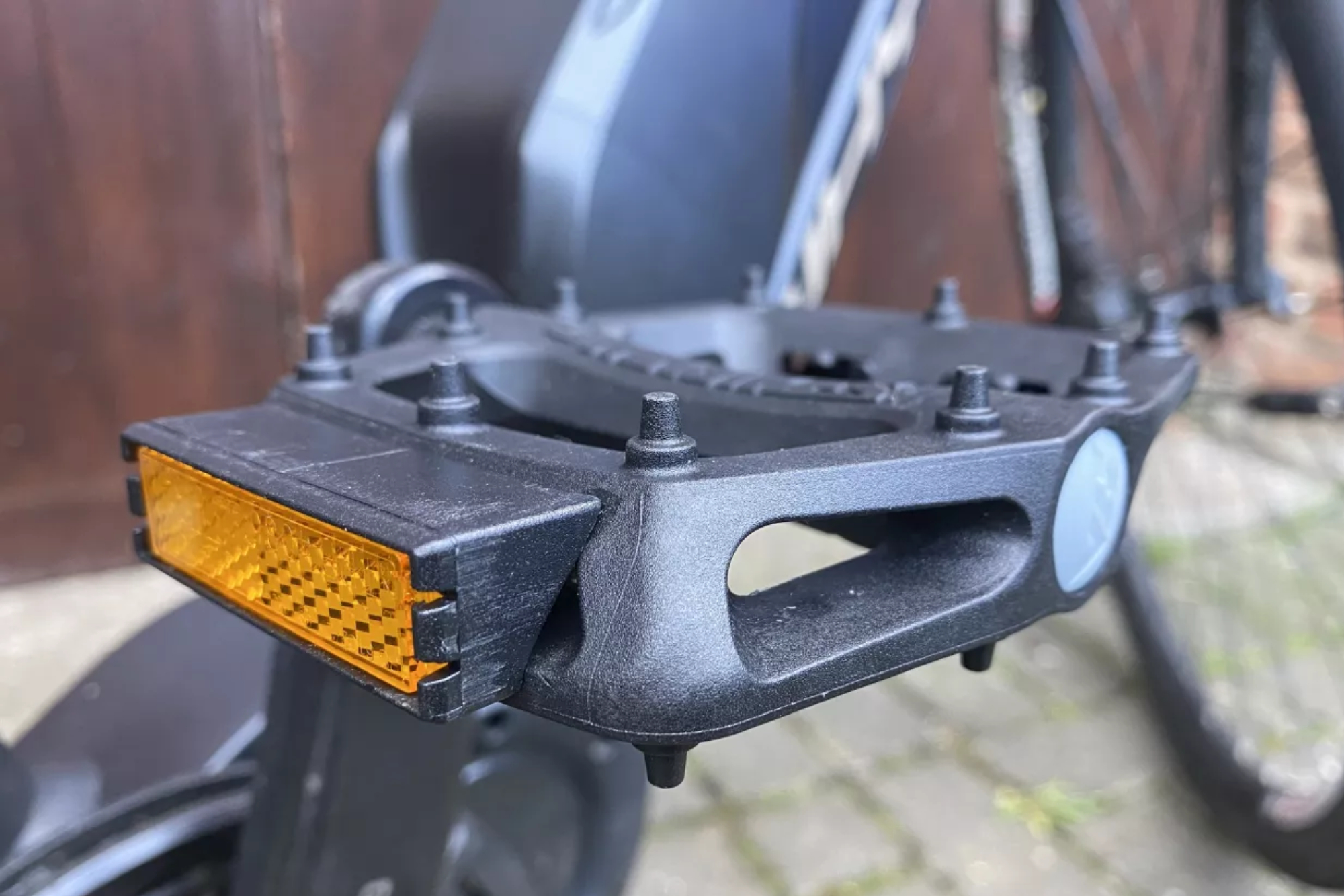 Image shows the DMR V6 flat pedals mounted on a bike