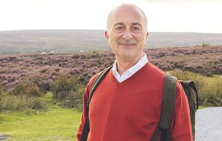 Tony Robinson heaves on his backpack for the final leg of his 190-mile journey across England.