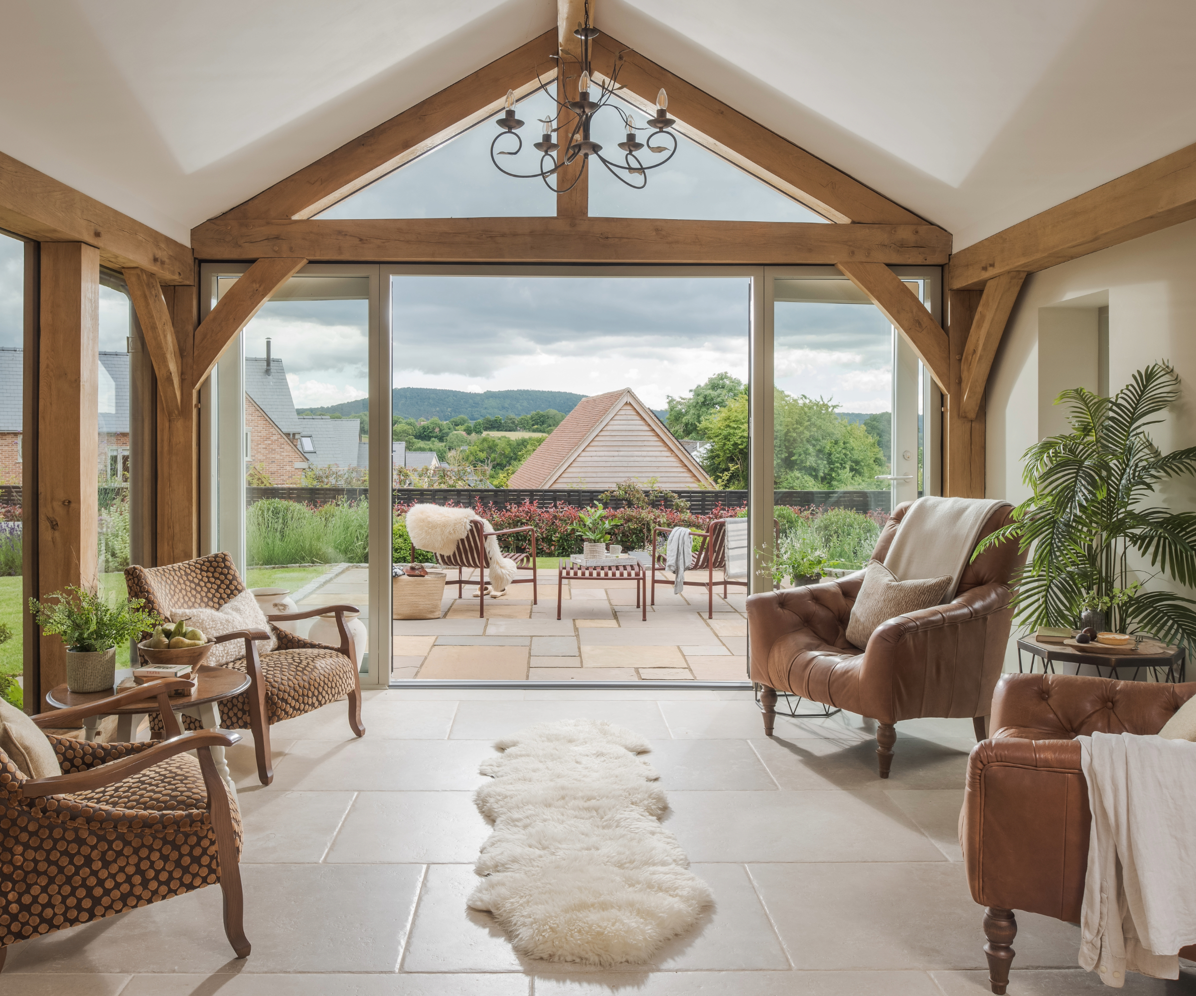 Garden room opens onto the patio through floor-to-ceiling windows