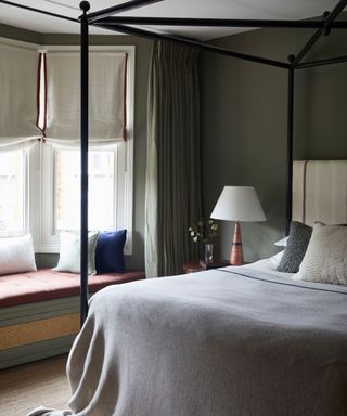 Dark green bedroom with window seat