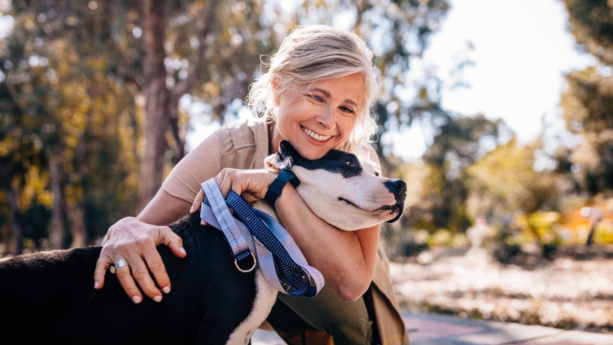 Woman hugging dog outside