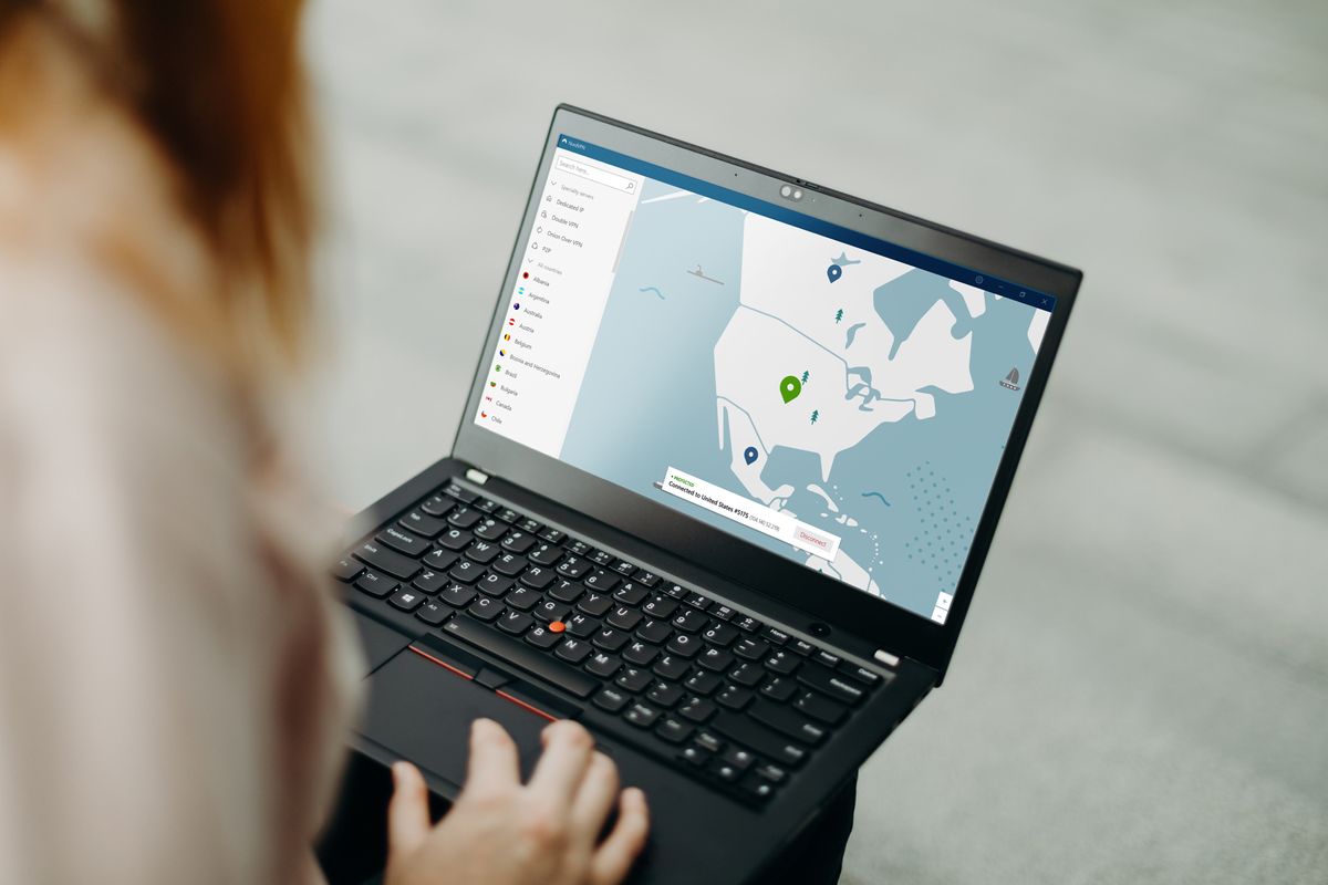 Person using NordVPN on a laptop to connect to a VPN server in the US