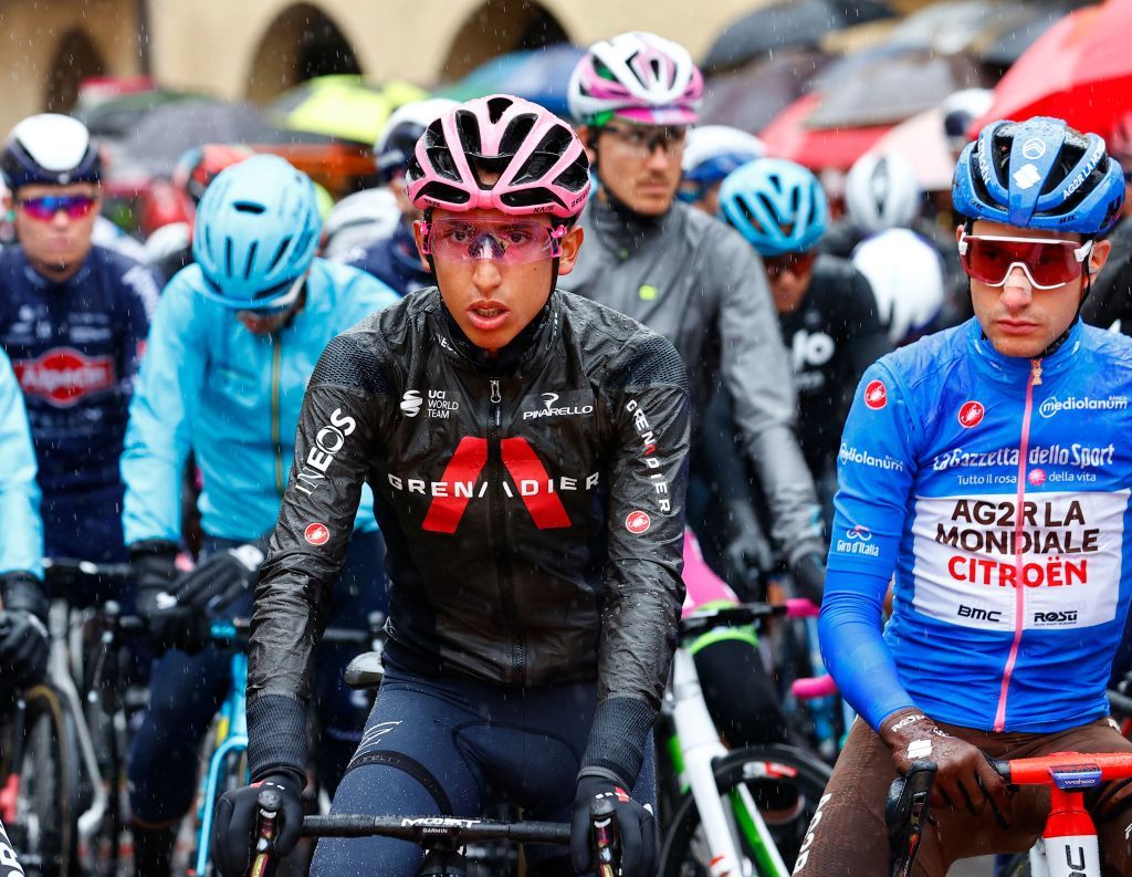 Overall leader Team Ineos rider Colombias Egan Bernal C Team AG2R rider Frances Geoffrey Bouchard R wearing the best climbers blue jersey and other riders prepare to take the start of the 16th stage of the Giro dItalia 2021 cycling race 153km between Sacile and Cortina dAmpezzo on May 24 2021 Photo by Luca Bettini AFP Photo by LUCA BETTINIAFP via Getty Images