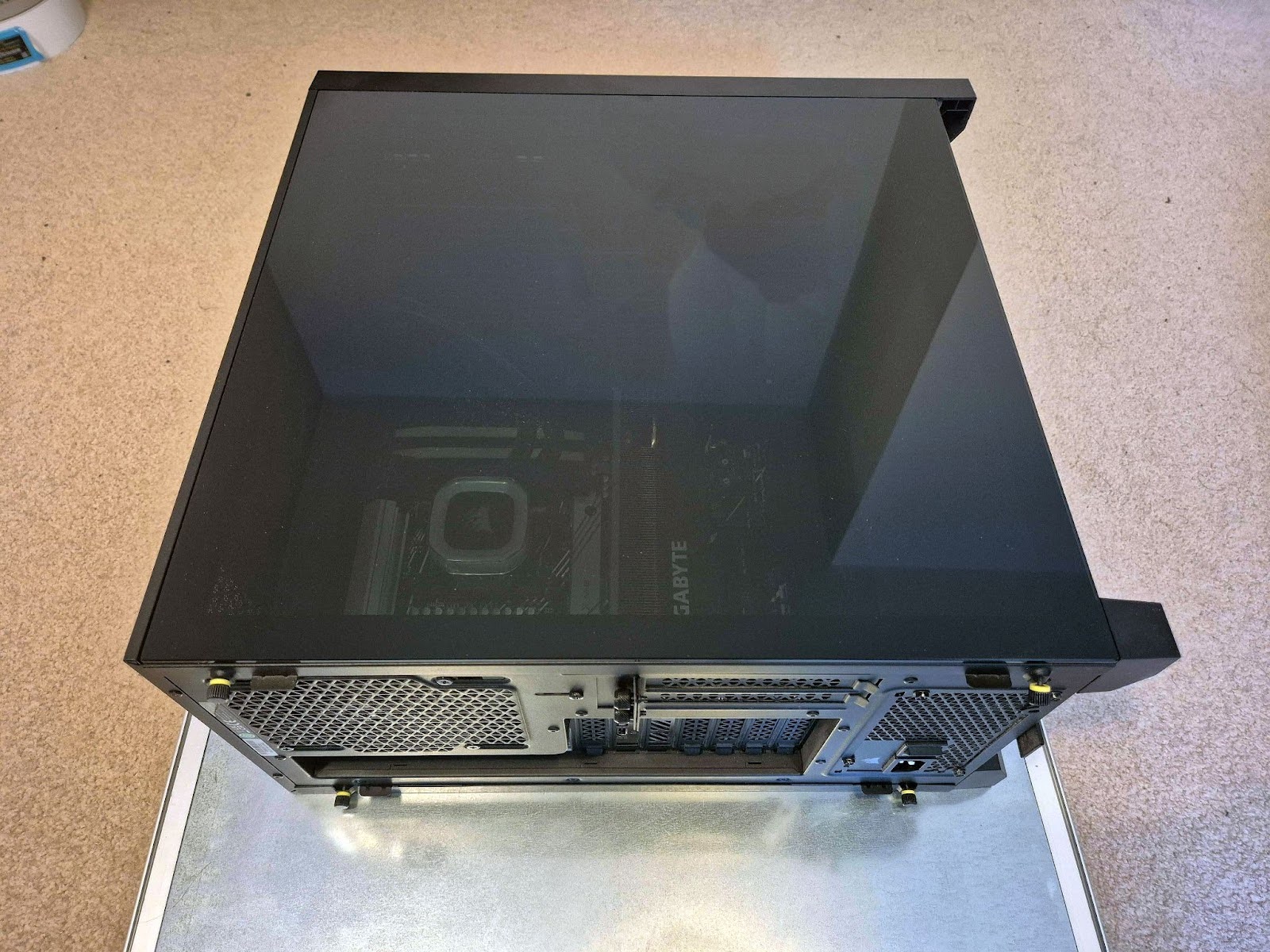 A PC rests on its side, showing the rear and side panels of the chassis.