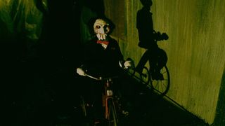 Billy the puppet rides a bicycle 
