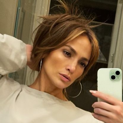 Jennifer Lopez wearing a gray cropped sweatshirt and matching joggers from Joah Brown in Instagram selfie May 2024