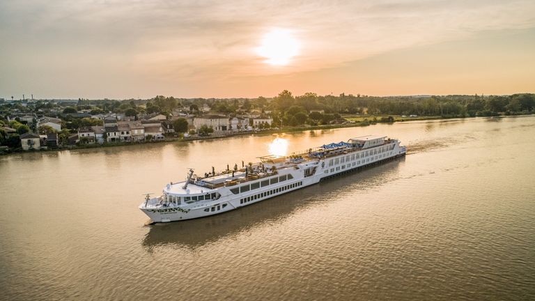 A Uniworld European cruise ship, one of the best river cruises in Europe, on the river at sunrise 
