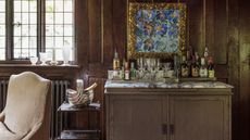 Home bar with marble counter and wood-panelled walls