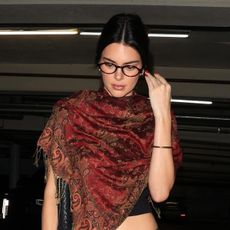 Kendall jenner wears a printed red scarf with opticals.