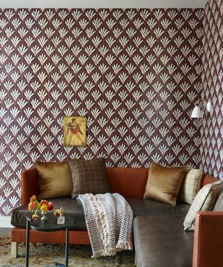 living room with corner sofa and dark brown patterned wallpaper