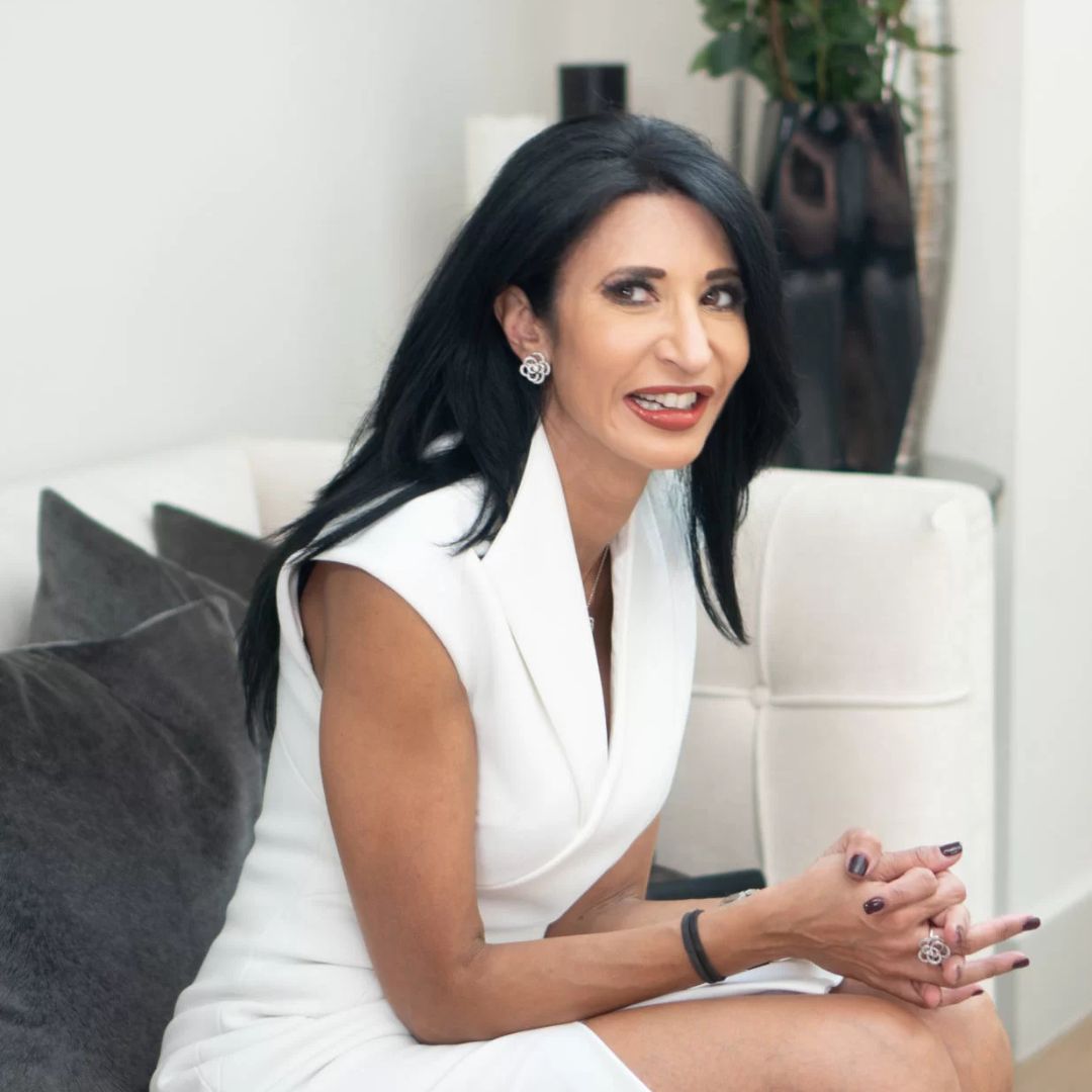 Dr Preema Vig pictured in a clinic, wearing a white dress