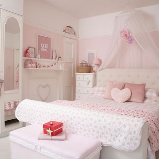 girls bedroom with pink wall and mirror