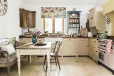 kitchen_with_pink_range_cooker_decorative_tiles_wooden_furniture