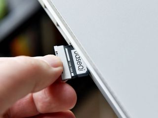 Slide the card and adapter into the SD slot.