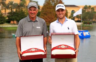 Mike and Justin Thomas hold the PNC Championship trophy