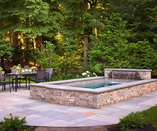 plunge pool with waterfall on patio