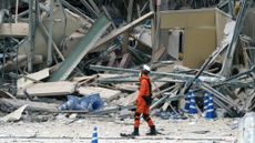 A firefighter searches for missing people at Aeon Mall Kumamoto