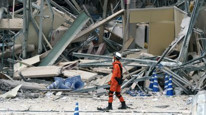 A firefighter searches for missing people at Aeon Mall Kumamoto