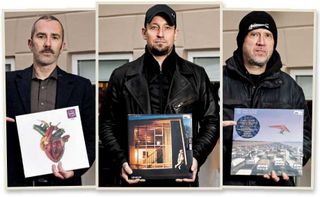 The members of Volbeat holding the records they purchased