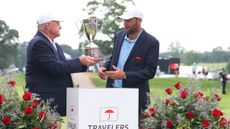 Scottie Scheffler receives the Travelers Championship trophy