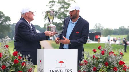 Scottie Scheffler receives the Travelers Championship trophy