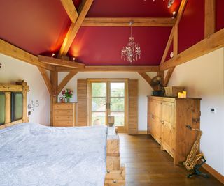 bedroom with vaulted ceiling painted red