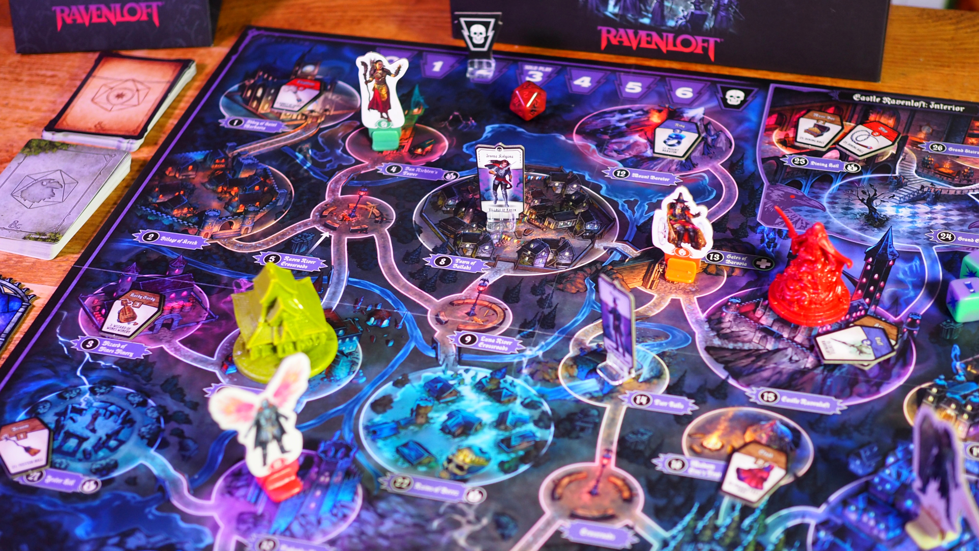 Horrified Ravenloft board with icons, tokens, and miniatures across it, with cards visible to one side