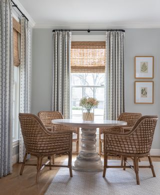 Table with woven chairs and curtains on French return rod