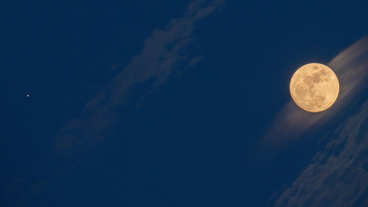 A 95 percent illuminated waxing gibbous moon and Jupiter planet (astral conjunction) rise in Rocca Calascio (LAquila), Italy, on october 8, 2022.