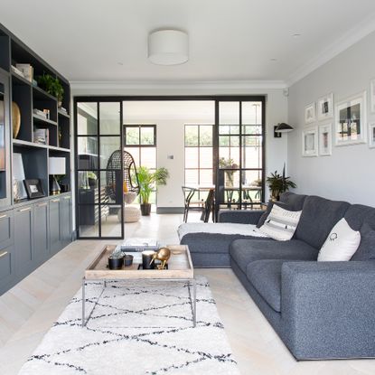 Living room with wall of glazing between the room and the dining room
