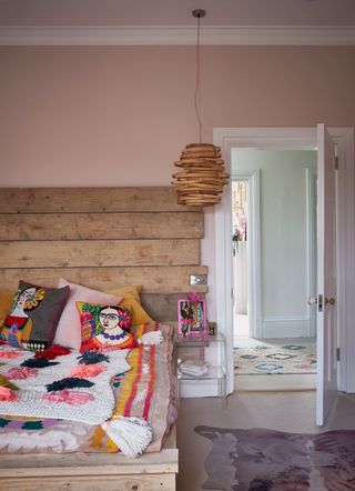 Pink bedroom with wooden headboard