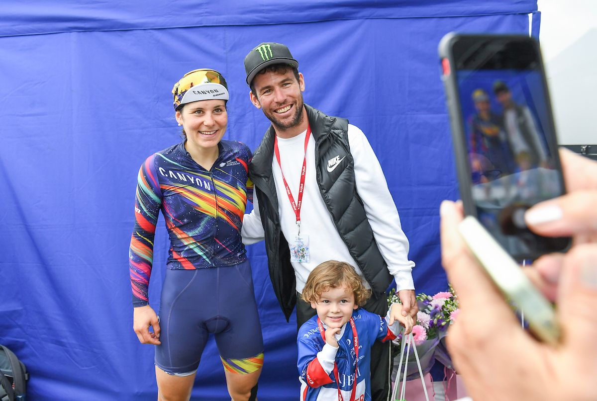Picture by Simon Wilkinson/SWpix.com - 08/10/2021 - Cycling - AJ Bell Women's Tour of Britain - Stage Five: Colchester to Clacton-on-Sea, England - Mark Cavendish with son Casper photographed with Canyon SRAM's Elise Chabbey.