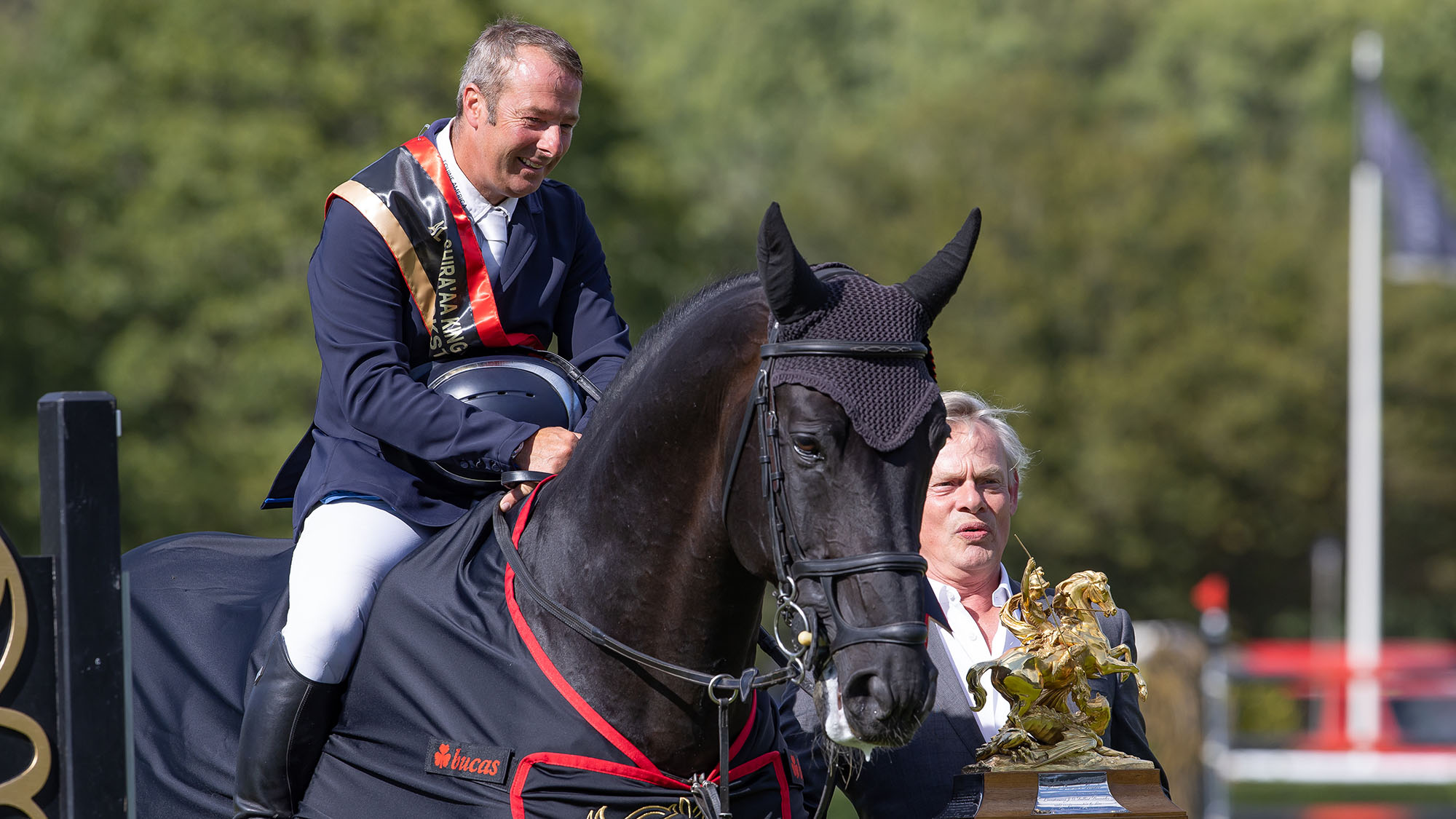 Robert Whitaker and Equine America Vermento accept the King George V Gold Cup trophy from Martin Clunes at the Agria Royal International Horse Show 2026