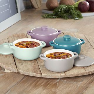 multi colour casserole dishes on wooden table