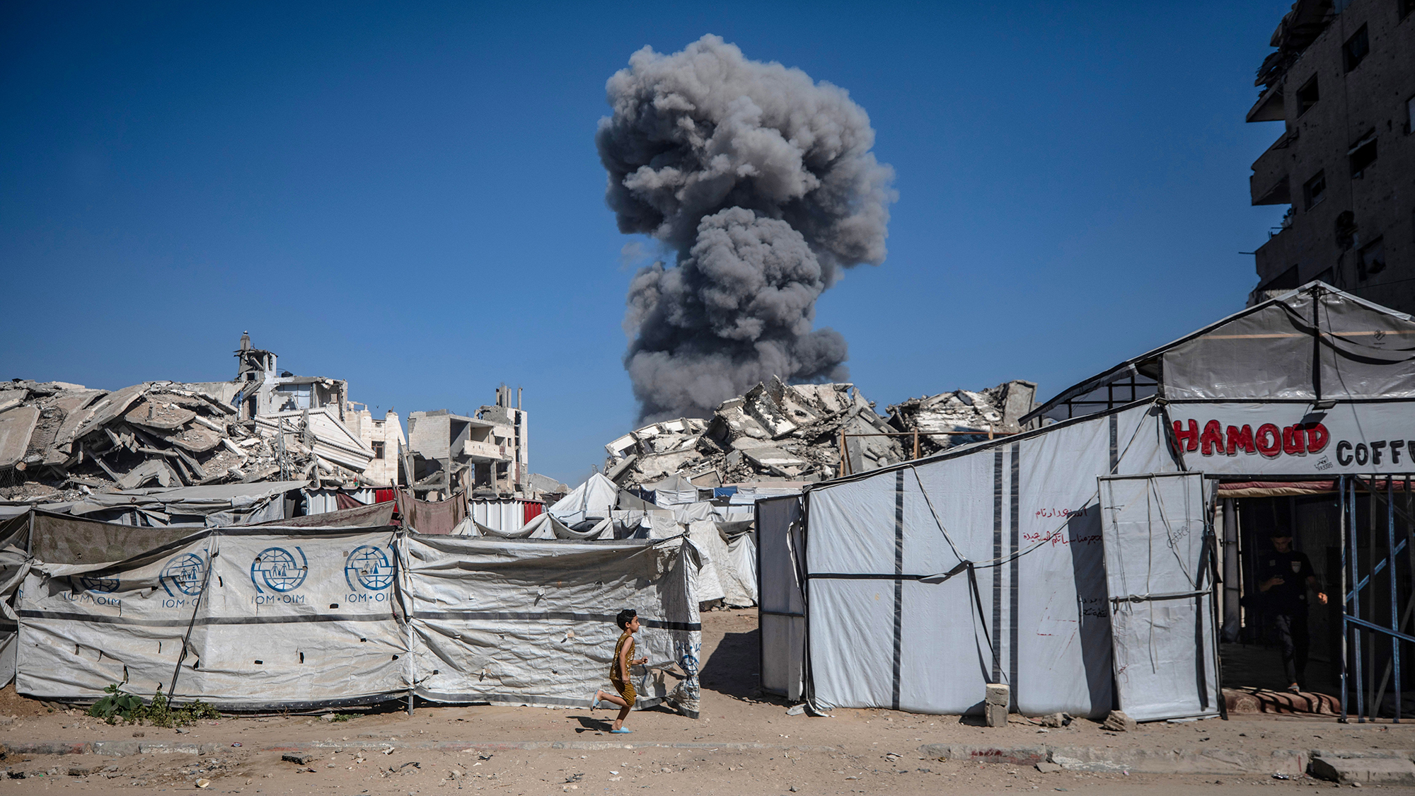 A column of smoke rises following an Israeli airstrike in southern Gaza City, Palestine