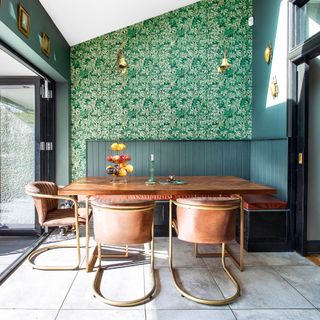 Kitchen with botanical wallpaper, panelled booth and green walls