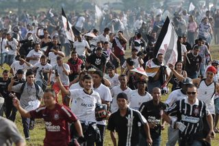 Corinthians fans rush to greet their team at the airport after their Club World Cup final win over Chelsea in December 2012.