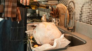  Oil being poured over brined Turkey 