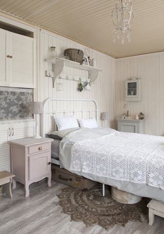 White wrought iron bed in cottage bedroom