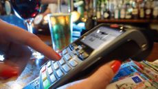 Woman paying by card for drinks in a bar