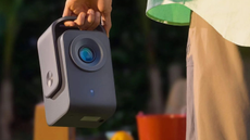 Lifestyle shot of someone carrying a TCL Projector C1