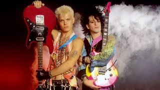 Billy Idol (left) and Steve Stevens hold guitars as they pose in Munich, German, June 25, 1984. 