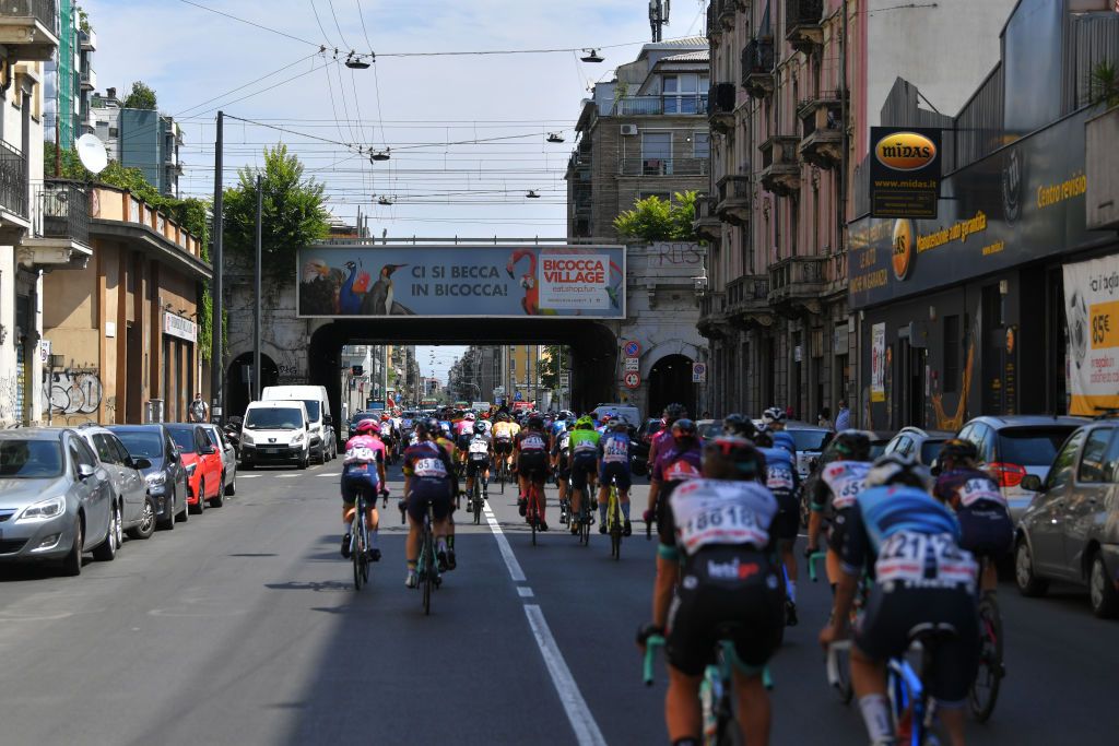 CARUGATE ITALY JULY 06 The peloton passing through the traffic at the start in Milan City during the 32nd Giro dItalia Internazionale Femminile 2021 Stage 5 a 1201km stage from Milano to Carugate GiroDonne UCIWWT on July 06 2021 in Carugate Italy Photo by Luc ClaessenGetty Images
