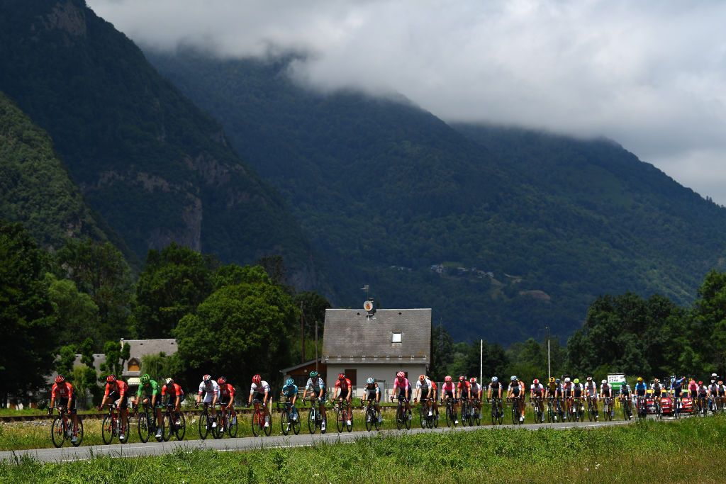 The break races along a valley road on stage 12
