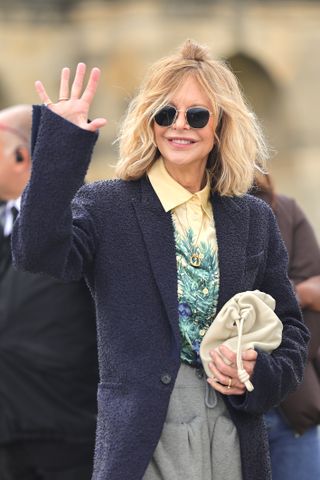 Meg Ryan at Paris Fashion Week carrying a Loewe purse with her fancy sweatpants