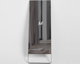 Image of MIRROR on grey backdrop with M logo