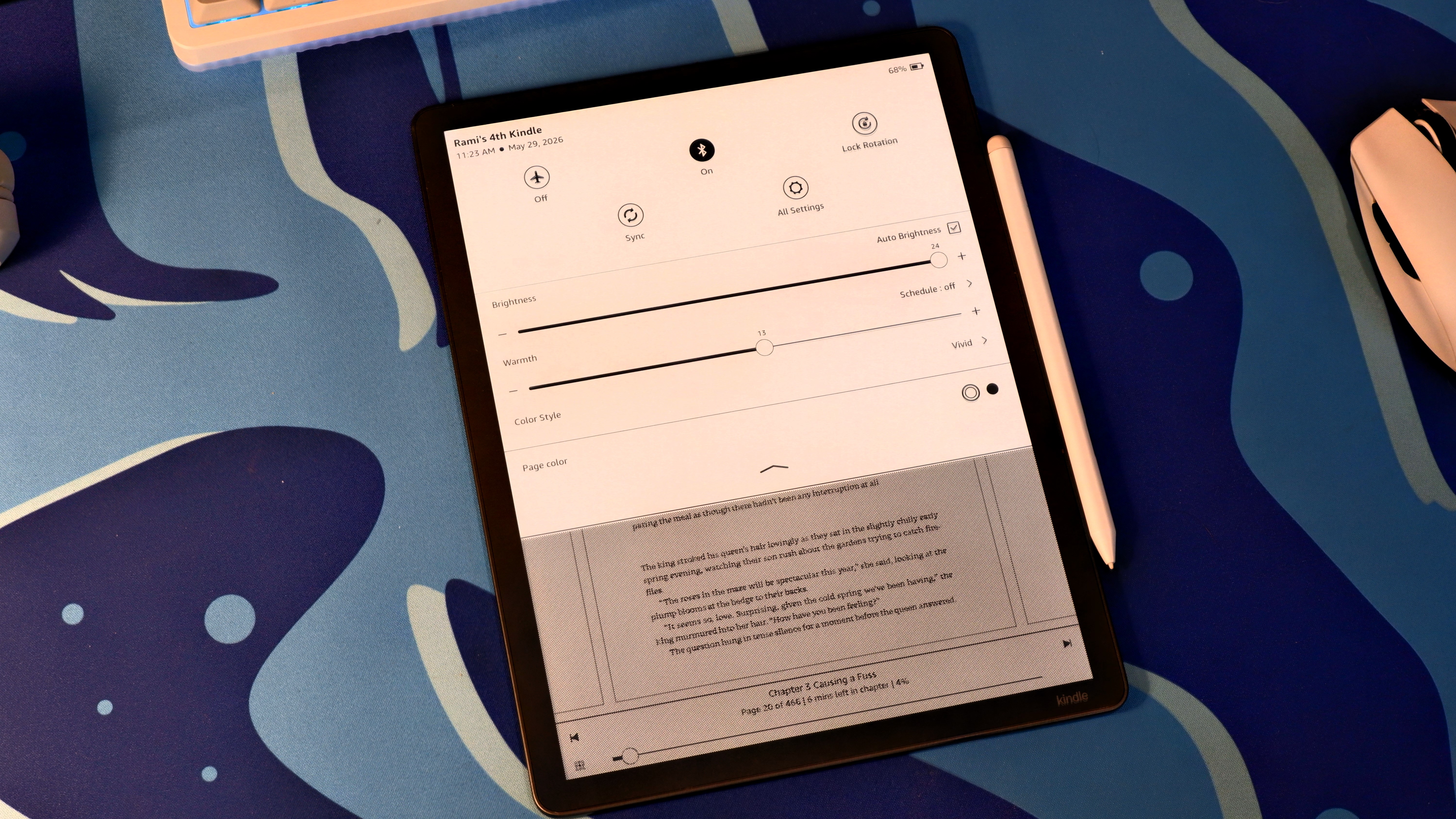 Amazon Kindle Scribe Colorsoft on a blue desk, showcasing the settings tab.