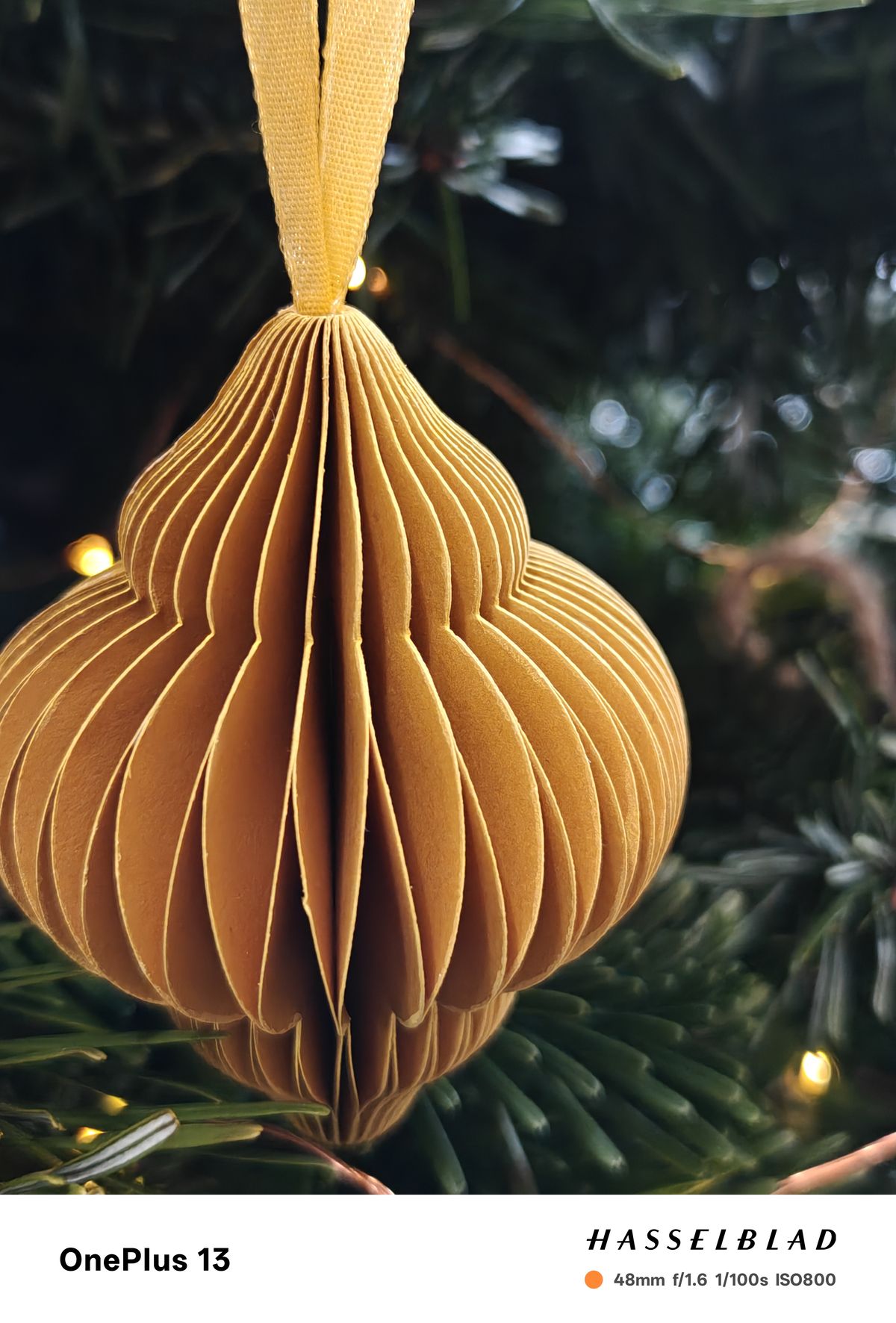 Close-up of a paper decoration hanging on a Christmas tree